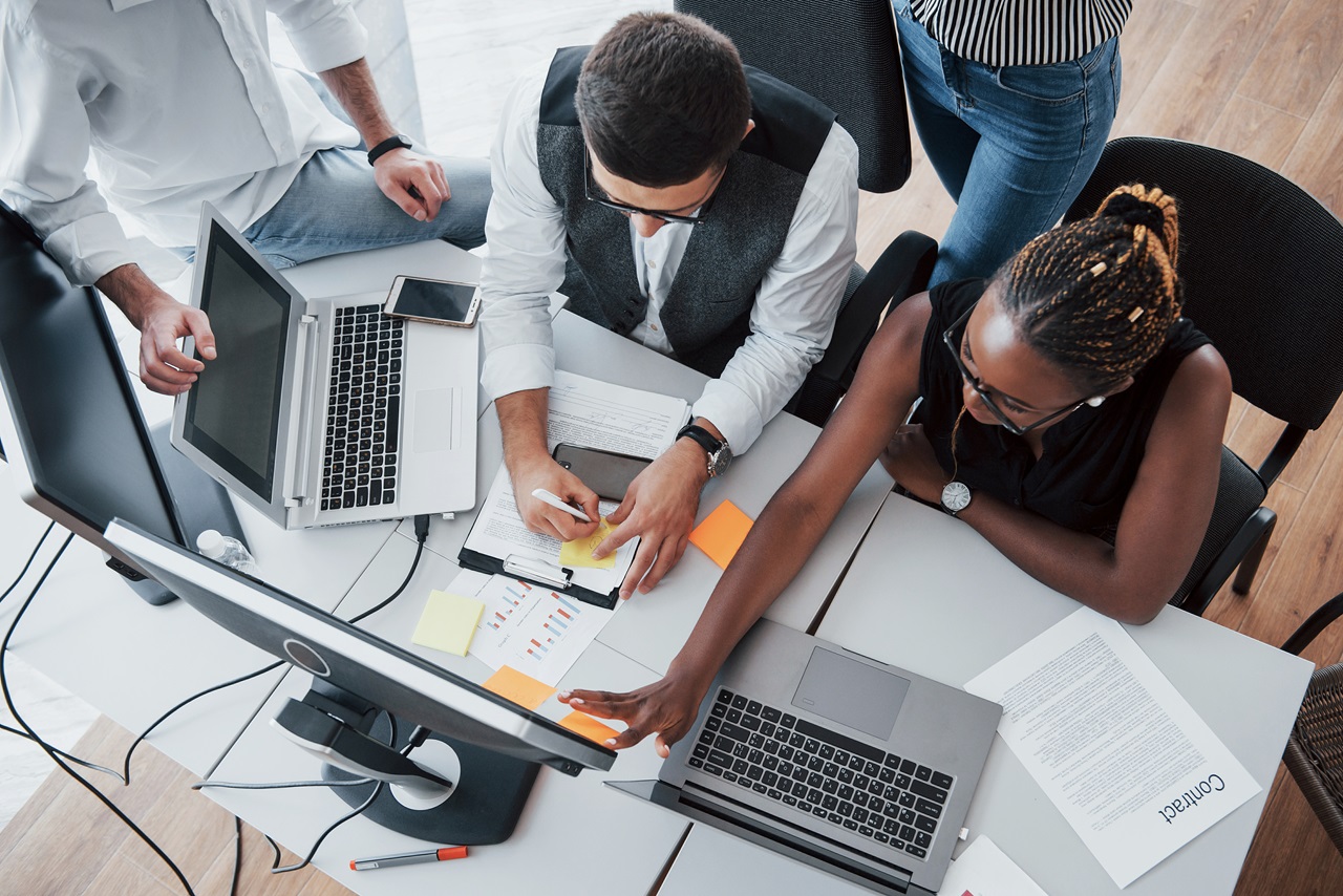 A group of multinational busy people working in the office. A group of multinational busy people working in the office. Height view